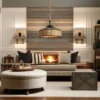Dans un salon cosy, un canapé beige orné de coussins noirs et blancs est placé devant une cheminée allumée. Deux appliques encadrent la cheminée, et au-dessus est suspendu le Lustre vintage rustique CORDA Noir beige, à l'allure unique. En dessous se trouve un pouf rond posé sur un tapis à motifs.